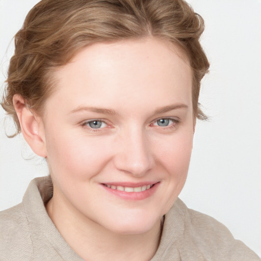 Joyful white young-adult female with medium  brown hair and blue eyes