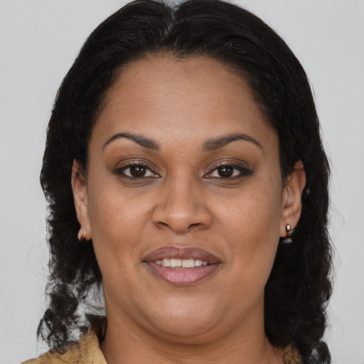 Joyful latino adult female with medium  brown hair and brown eyes