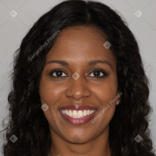 Joyful black young-adult female with long  brown hair and brown eyes