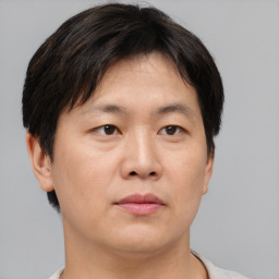Neutral asian young-adult male with short  brown hair and brown eyes