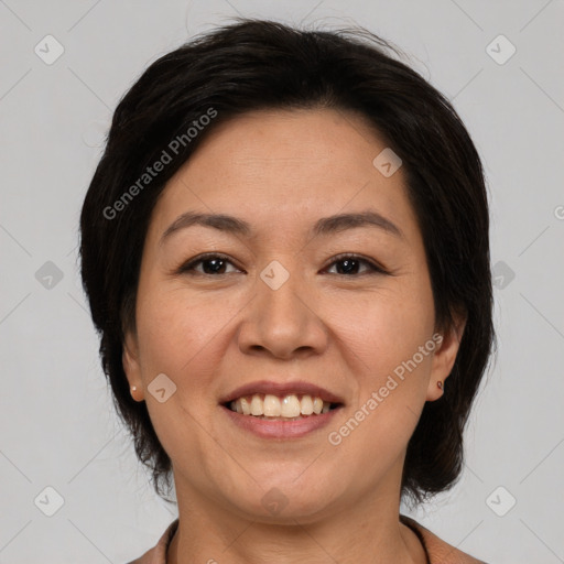 Joyful asian adult female with medium  brown hair and brown eyes