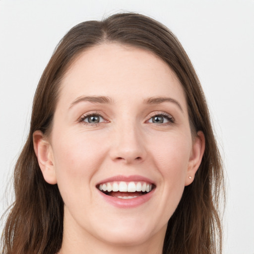 Joyful white young-adult female with long  brown hair and grey eyes