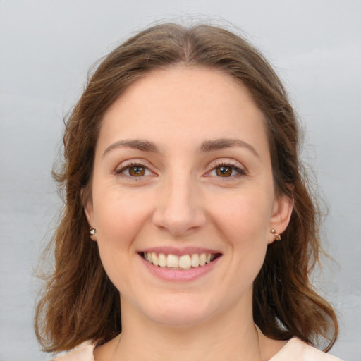 Joyful white young-adult female with medium  brown hair and green eyes