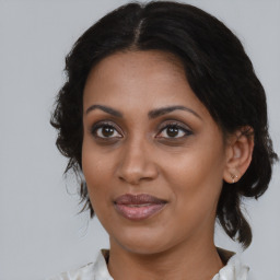 Joyful black young-adult female with medium  brown hair and brown eyes