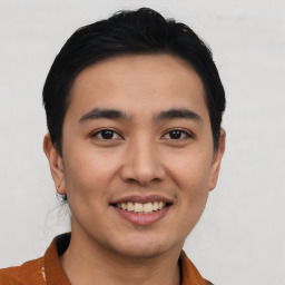 Joyful asian young-adult male with short  brown hair and brown eyes