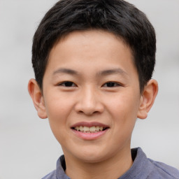 Joyful white child male with short  brown hair and brown eyes