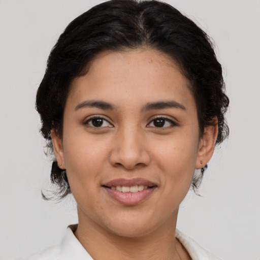 Joyful latino young-adult female with medium  brown hair and brown eyes