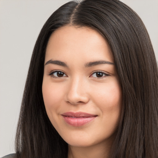 Joyful white young-adult female with long  black hair and brown eyes