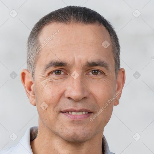 Joyful white adult male with short  brown hair and brown eyes