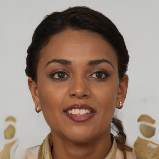 Joyful black young-adult female with short  brown hair and brown eyes