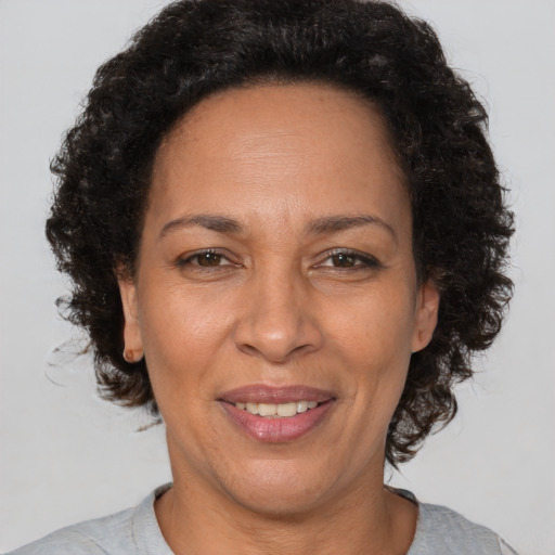 Joyful black adult female with short  brown hair and brown eyes