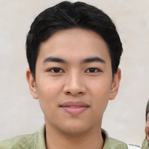 Joyful asian young-adult male with short  black hair and brown eyes