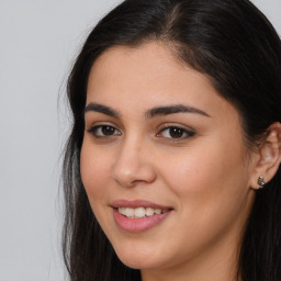 Joyful latino young-adult female with long  brown hair and brown eyes