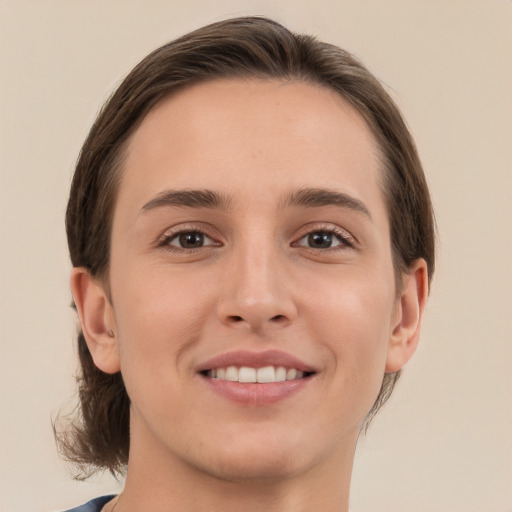 Joyful white young-adult female with medium  brown hair and brown eyes