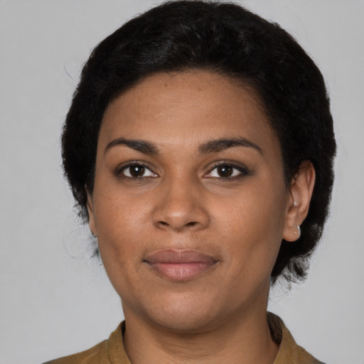 Joyful black young-adult female with medium  black hair and brown eyes