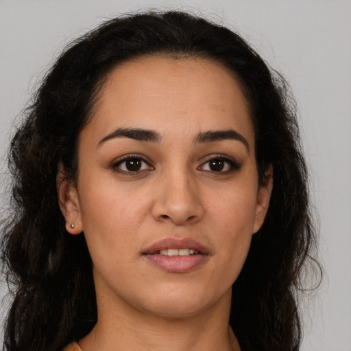 Joyful latino young-adult female with long  brown hair and brown eyes