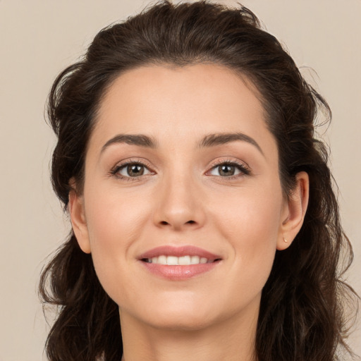 Joyful white young-adult female with long  brown hair and brown eyes