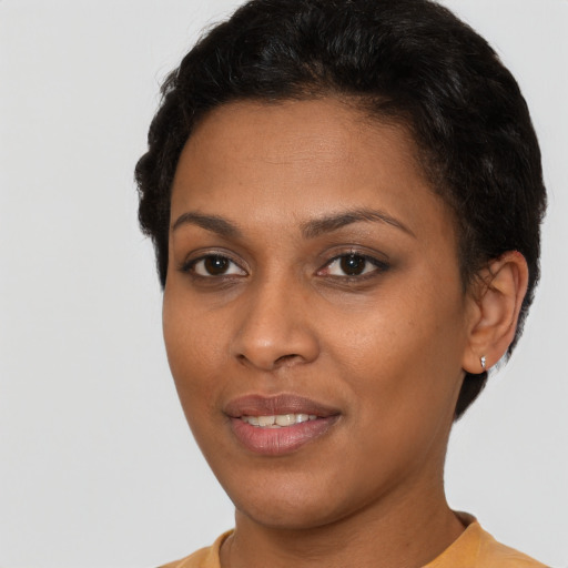 Joyful black young-adult female with short  brown hair and brown eyes