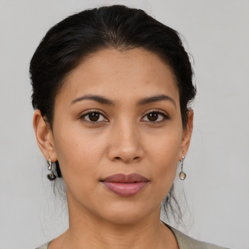 Joyful latino young-adult female with short  brown hair and brown eyes