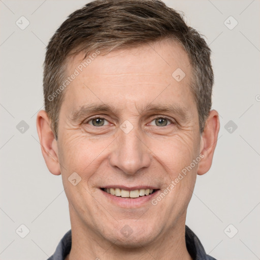 Joyful white adult male with short  brown hair and brown eyes