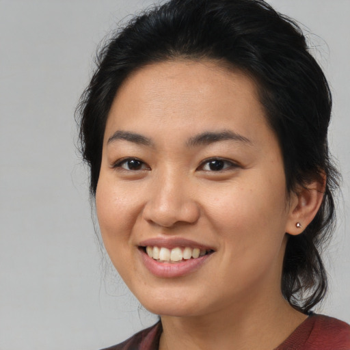 Joyful asian young-adult female with medium  brown hair and brown eyes