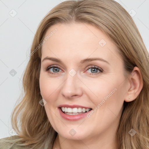 Joyful white young-adult female with long  brown hair and blue eyes