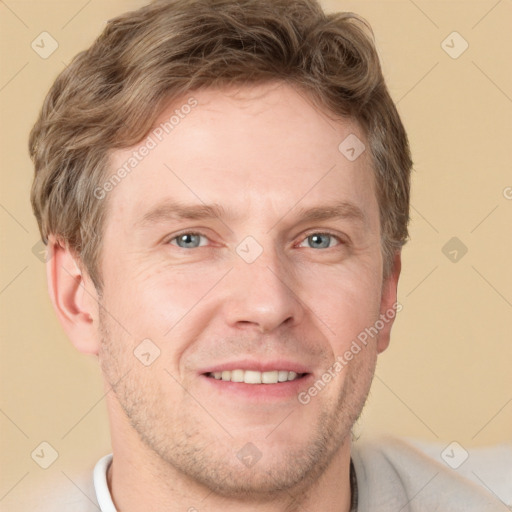 Joyful white adult male with short  brown hair and grey eyes