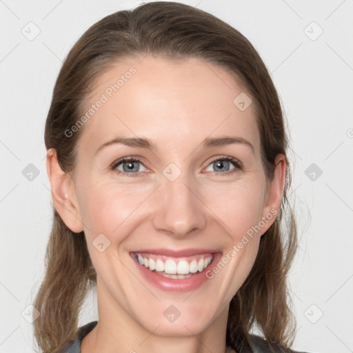 Joyful white young-adult female with long  brown hair and grey eyes