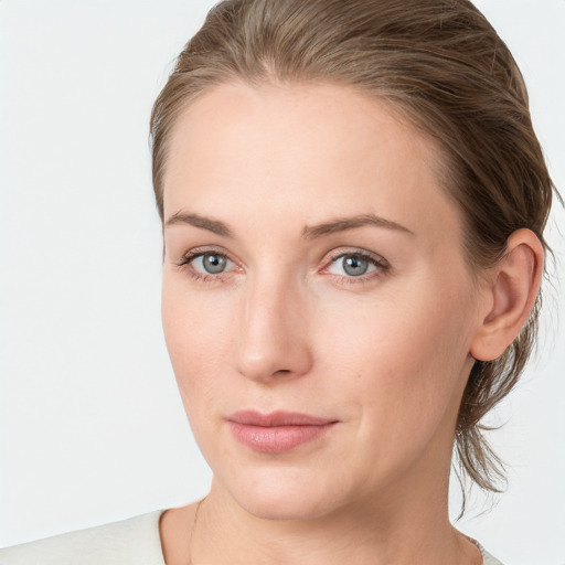 Joyful white young-adult female with medium  brown hair and blue eyes