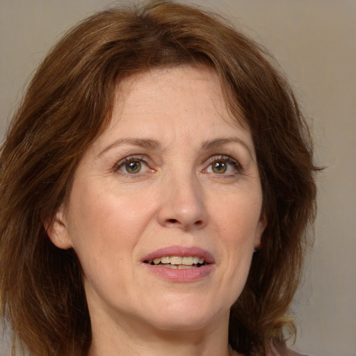 Joyful white adult female with medium  brown hair and brown eyes