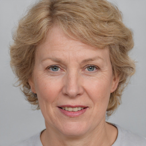 Joyful white middle-aged female with medium  brown hair and blue eyes