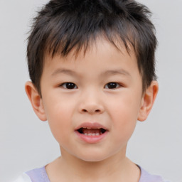 Joyful white child male with short  brown hair and brown eyes