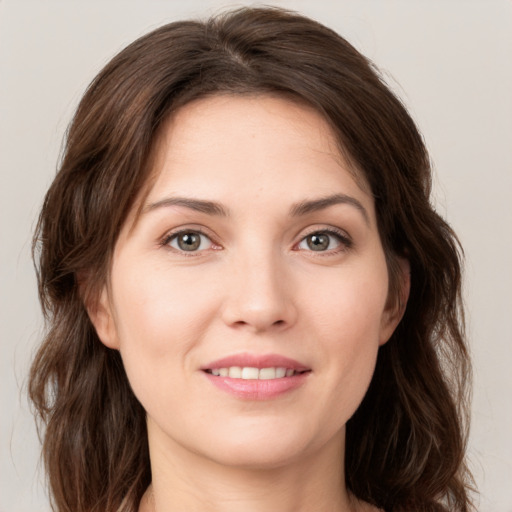 Joyful white young-adult female with medium  brown hair and green eyes