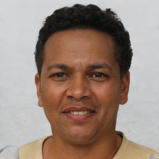 Joyful latino adult male with short  brown hair and brown eyes