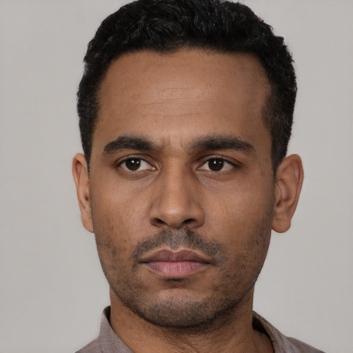 Neutral latino young-adult male with short  black hair and brown eyes