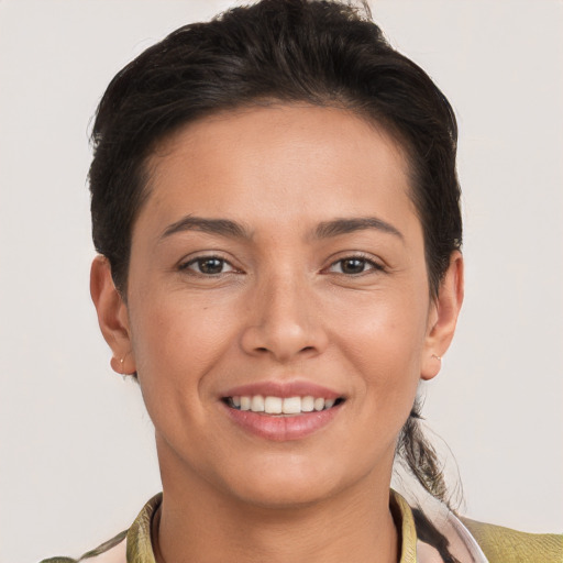 Joyful white young-adult female with short  brown hair and brown eyes