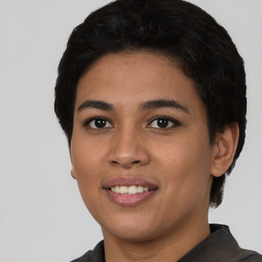 Joyful latino young-adult female with short  black hair and brown eyes