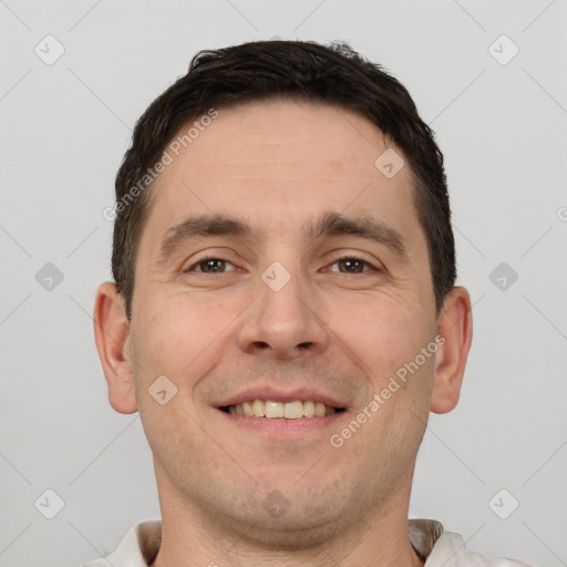 Joyful white young-adult male with short  brown hair and brown eyes