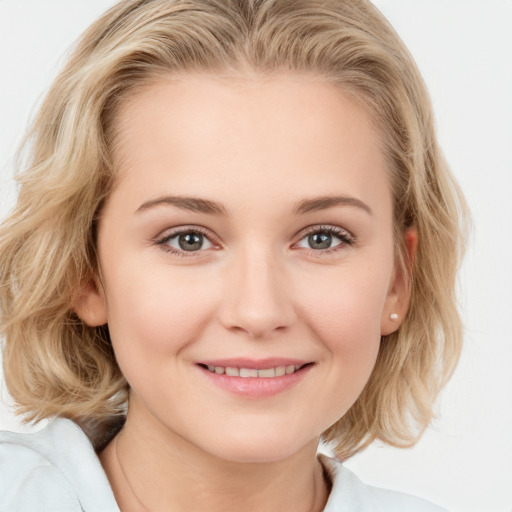 Joyful white young-adult female with medium  brown hair and blue eyes