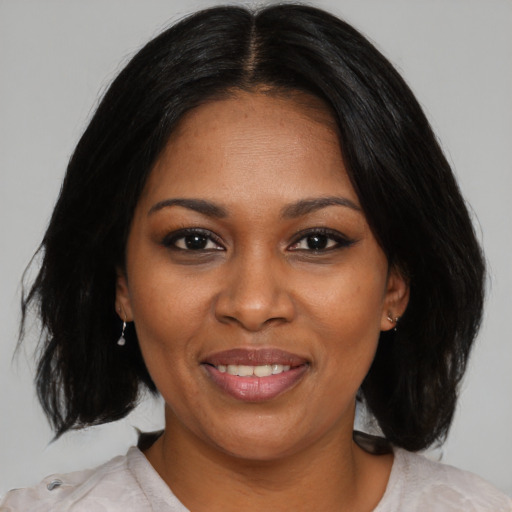 Joyful black young-adult female with medium  black hair and brown eyes
