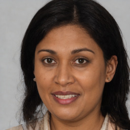 Joyful black adult female with medium  brown hair and brown eyes