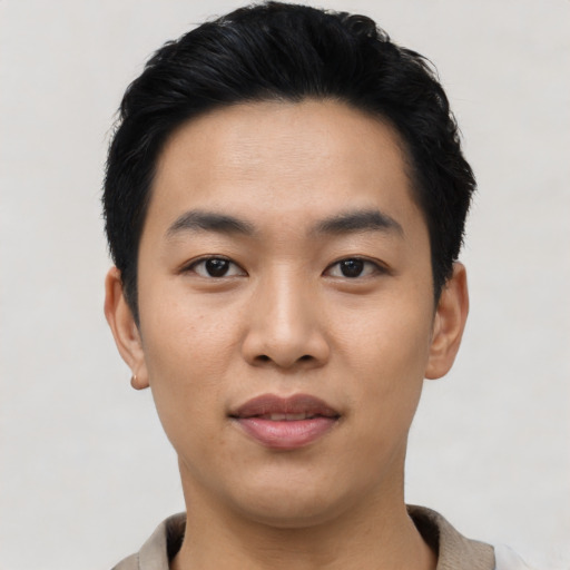 Joyful asian young-adult male with short  black hair and brown eyes