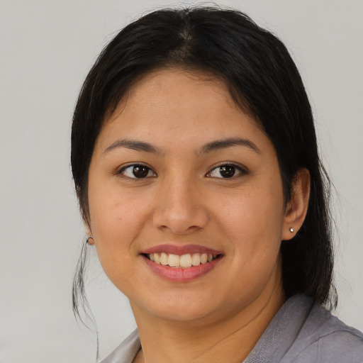 Joyful asian young-adult female with medium  brown hair and brown eyes