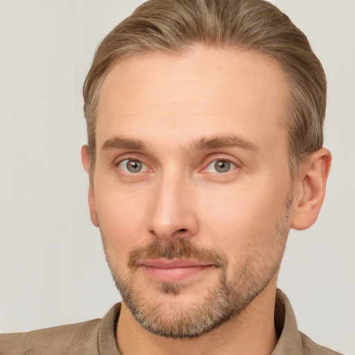 Joyful white adult male with short  brown hair and grey eyes