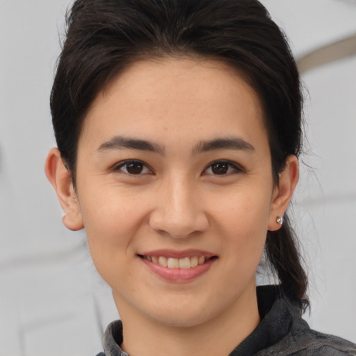 Joyful white young-adult female with medium  brown hair and brown eyes