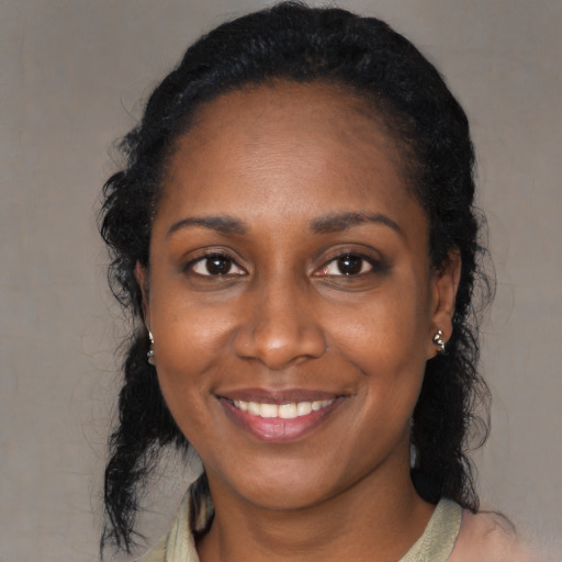 Joyful black young-adult female with medium  black hair and brown eyes