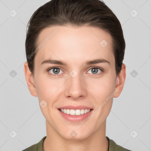 Joyful white young-adult female with short  brown hair and grey eyes