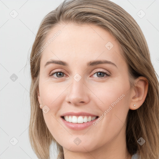 Joyful white young-adult female with long  brown hair and grey eyes