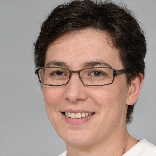 Joyful white adult female with medium  brown hair and green eyes