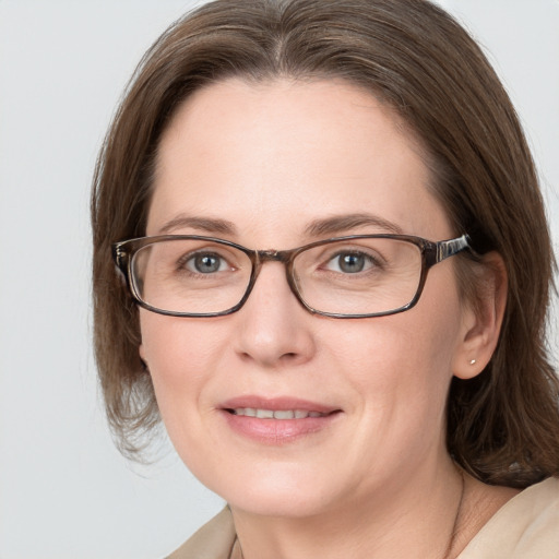 Joyful white adult female with medium  brown hair and grey eyes